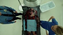 Tyler's headless and charred corpse