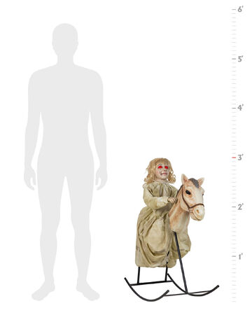 creepy doll on rocking horse