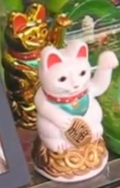 Two waving cats