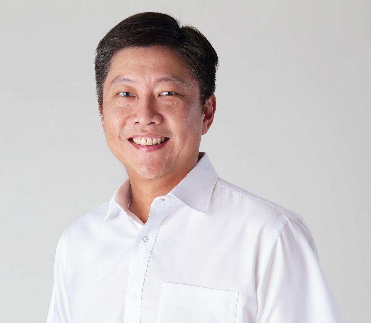 Ng Chee Meng smiling while wearing a white long sleeves