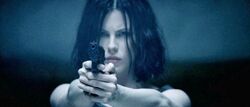 Selene firing a USP Compact in the shooting range