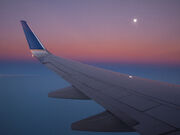 20101116104656 airplane wing and full moon 1000332 12x16