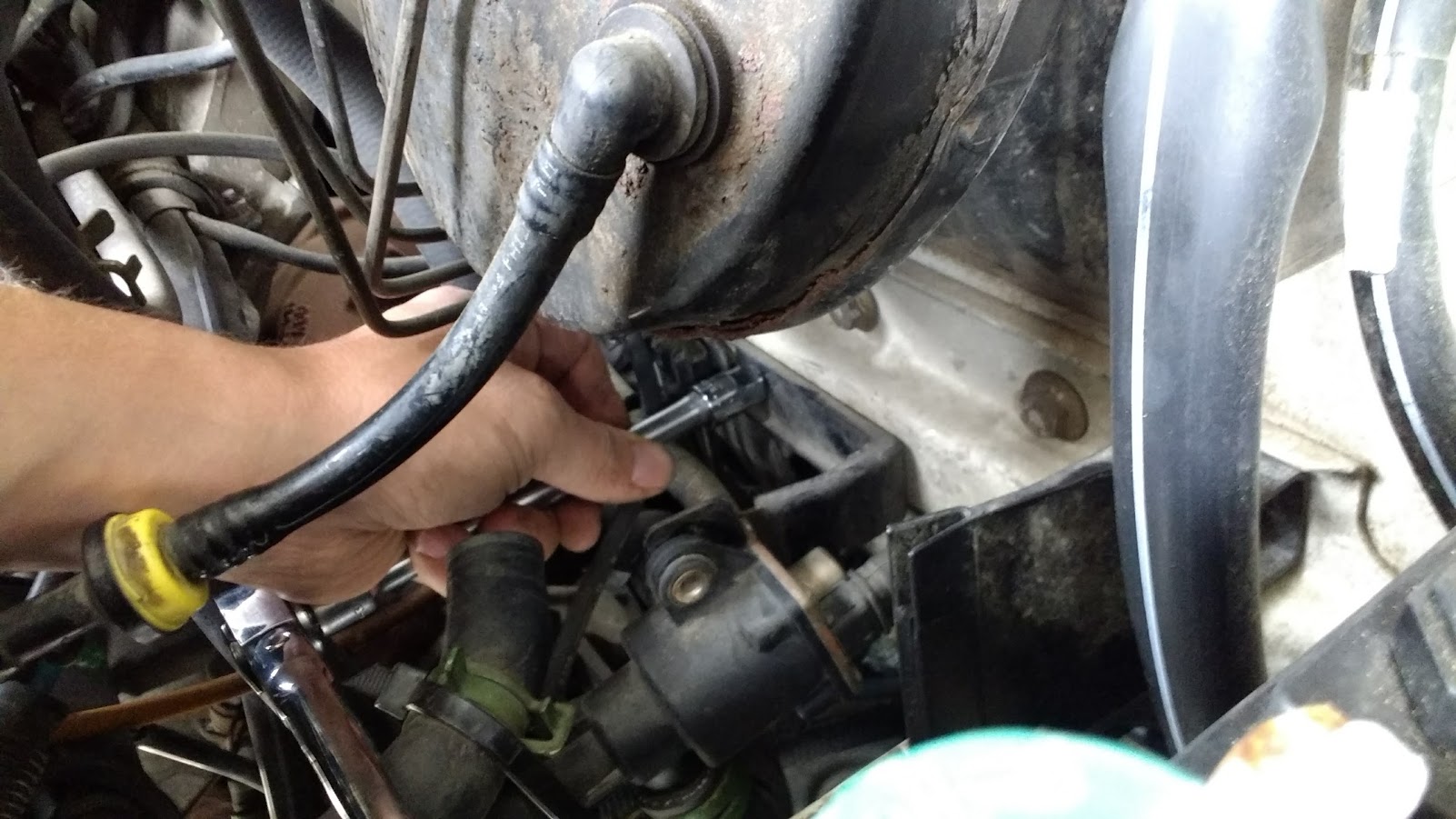 Remove plastic trim piece to left of battery (image 1). Bracket on firewall