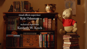 Winnie the Pooh is a stuffed bear on a stack of books to get the honey pot