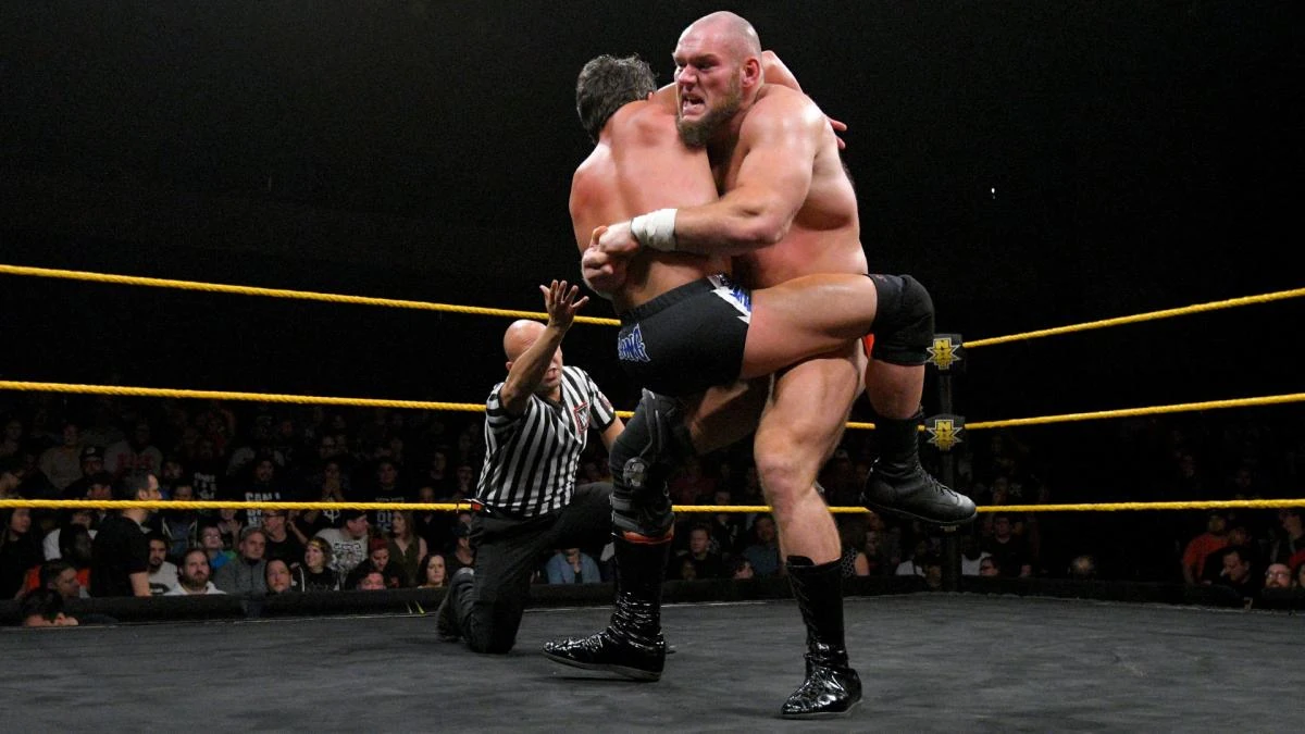 Image Sullivan putting a bear hug on Strong.jpg OfficialWWE Wiki
